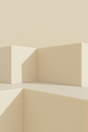 Minimalist light beige structure with geometric forms and angular shadows