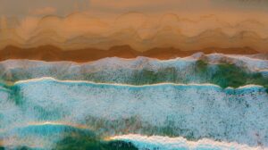 Aerial view of ocean waves forming foamy lines as they reach a sandy beach with layered colors.